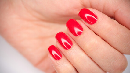 Female hands with beautiful bright red nails closeup