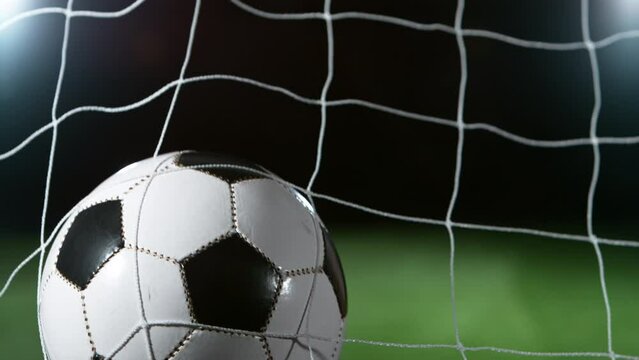 Close-up of Soccer Ball Hitiing Goal Net