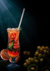 Ice cold Fresh fruit cocktail drink on dark background with copy space 