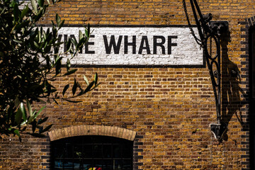Brick building with white written sign and iron work