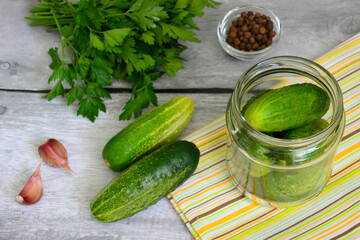 conservation of garden cucumbers in jar with spices, garlic and parsley