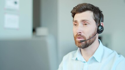 Corporate operator working in customer support service on helpline telesales. Focused man representative call center agent in wireless headset helping client with complaints using computer in office - Powered by Adobe