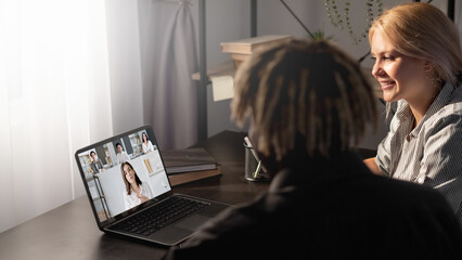 Group video call. Webinar class. Online learning teleconference. Diverse students watching female coach virtual presentation on laptop screen.