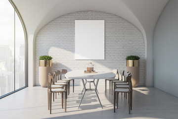 Blank white poster on brick wall in stylish dining area of modern apartment with white table surrounded by wooden chairs, golden flower pots and city view from arch window. 3D rendering, mockup
