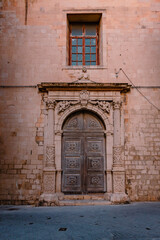 Fototapeta na wymiar Characteristic gateway in the historic centre of Ortigia, Syracuse