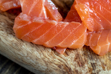 cutting fish fillets during the preparation of a dish of red salmon fish