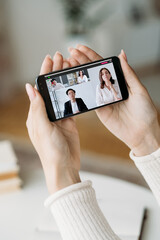 Virtual conference. Mobile video chat. Digital communication. Diverse business team working from home discussing project online on phone screen.