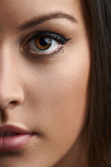 Closeup photo from a beautiful young womans half face, with a big beautiful brown eyes