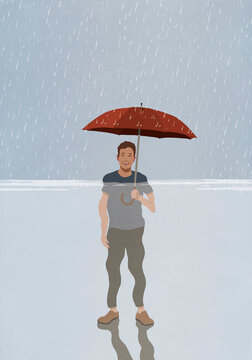 Portrait smiling man with umbrella standing in rain and flood rising water
