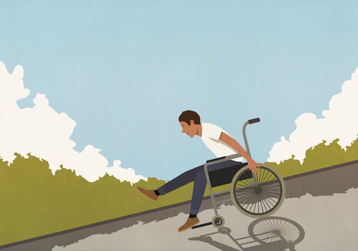 Happy, exhilarated man speeding downhill in wheelchair

