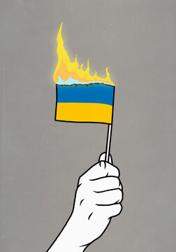 Hand holding burning Flag of Ukraine
