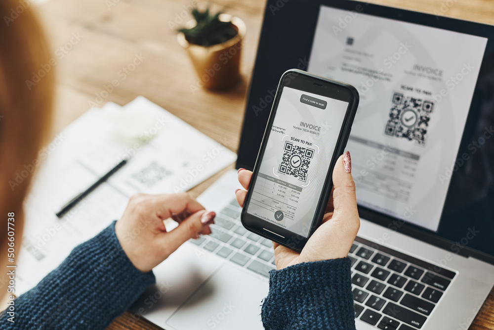 Wall mural woman scanning qr code from invoice to make payment using fast secure payment system and smartphone 