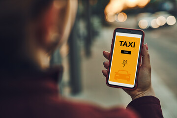 Woman ordering taxi online using mobile app on smart phone. Booking taxi using application online....