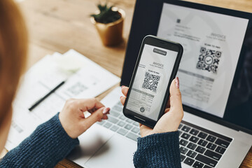 Woman scanning QR code from invoice to make payment using fast secure payment system and smartphone code reader. Business woman paying bills using express payment technology. Paying expenses online - 506607738