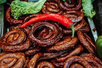 Homemade fried sausage rings, lettuce, chili peppers and paprika lie in the food area at the fair 1