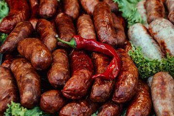 Homemade fried sausage, lettuce, chili peppers and paprika lie in the food area at the fair