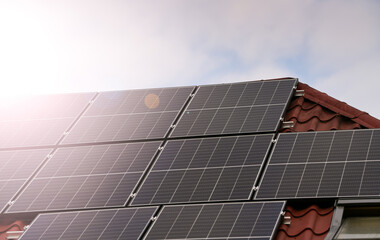 Energy from sun. A lot of solar panels are on the roof of a house. Photo during a sunny day with...