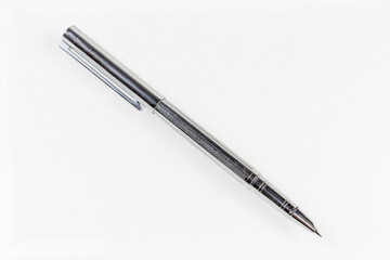 Modern fountain pen with open pen cap on light surface
