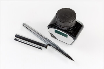 Modern fountain pen with removed cap and glass ink vial