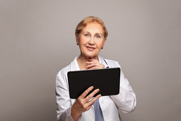 Woman doctor using digital tablet. Doctor in labcoat holding digital tablet, reading patient report