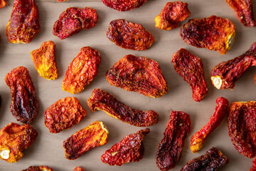 Slices of sun-dried tomatoes on wooden background
