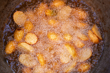 Baby potatoes fried in an iron pan in oil