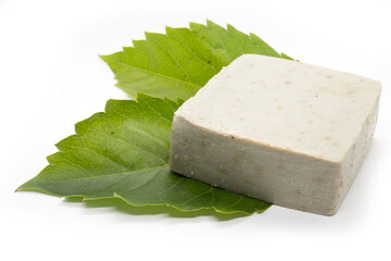 Handmade soap and two leaf on white background