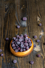 frozen blueberries on a wooden table