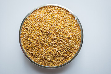 wheat grain circular container on white background overhead