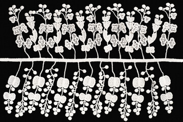 White lace with flowers, fruits and leaves on black background isolated. Sewing and fabric concept