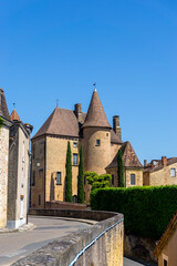 Obraz premium the Rue des Penitents leads to the city center of Belves with its historic brownstoen buildings