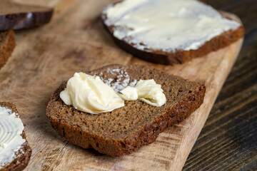 slices of black sliced bread with butter spread from milk