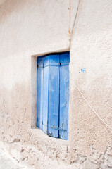 Architectural detail of building facade exterior mediterranean house with old wooden window shutters
