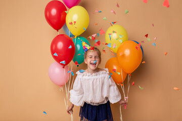 Happy Birthday party. Child girl with balloons on beige background