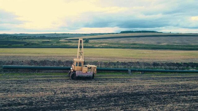 Pipeline construction. Tractor pipelayer lays a gas pipeline. Construction of a new gas pipeline. Construction of the pipeline.