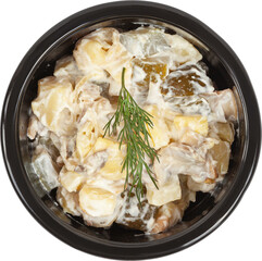 Fresh salad in a disposable round plastic black bowl top view on a white background
