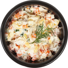 Fresh salad in a disposable round plastic black bowl top view on a white background