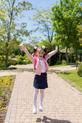 Back to school. Happy smiling kid go to elementary school. Child with school bag outdoors