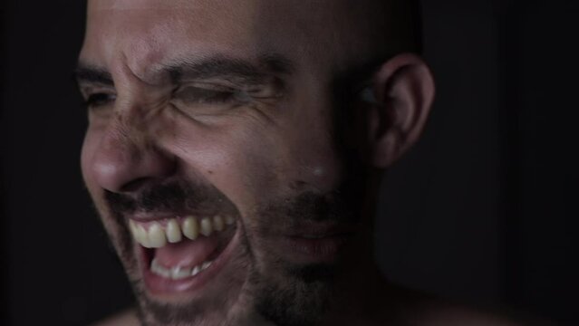 Disturbed man with schizophrenia symptoms. Low key light face with mental disorder. Bipolar personality concept, montage of different personalities