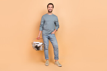 Fototapeta premium Full size photo of young cheerful man shop purchase discount supermarket isolated over beige color background