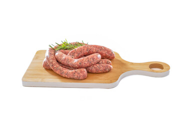 raw herb sausages on a wooden board on a white background