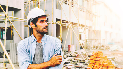 engineer stand to watch the progress of a house construction project.