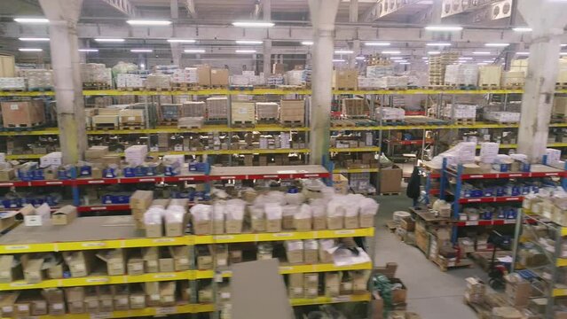 Span along shelves in a large warehouse. Modern warehouse. Industrial interior. Shelves with goods in stock.