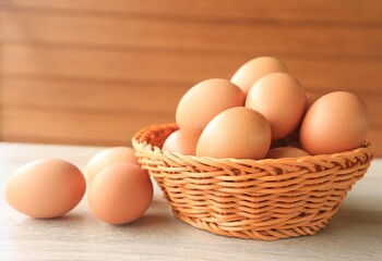 Eggs in a brown basket are placed on the table.