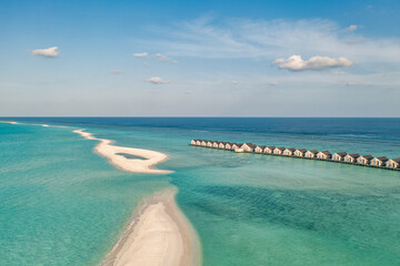 Maldives paradise scenery. Tropical aerial landscape, seascape with long jetty, water villas with amazing sea and lagoon beach, tropical nature. Exotic tourism destination banner, summer vacation
