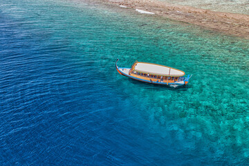 Maldivian exotic diving boat  in amazing ocean lagoon over coral ref. Snorkel and outdoor...