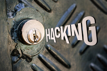 The inscription Hacking in the form of a key. Security, property protection. Keyhole close-up. Data unauthorized access symbol
