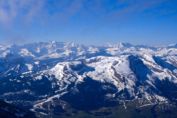 Fototapeta na wymiar Aerial view over the Swiss Alps with Churfirsten and Toggenburg Valley seen from Säntis peak at Alpstein Mountains on a sunny spring day. Photo taken April 19th, 2022, Säntis, Switzerland.