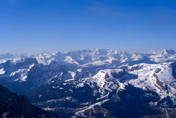 Fototapeta na wymiar Aerial view over the Swiss Alps with Churfirsten and Toggenburg Valley seen from Säntis peak at Alpstein Mountains on a sunny spring day. Photo taken April 19th, 2022, Säntis, Switzerland.
