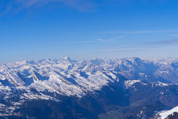 Aerial view over the Swiss Alps seen from Säntis peak at Alpstein Mountains on a sunny spring day. Photo taken April 19th, 2022, Säntis, Switzerland.